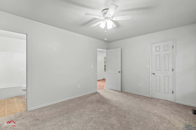 209 Norton Dr, Longview, TX 75602 - unfurnished bedroom featuring carpet floors, connected bathroom, and baseboards