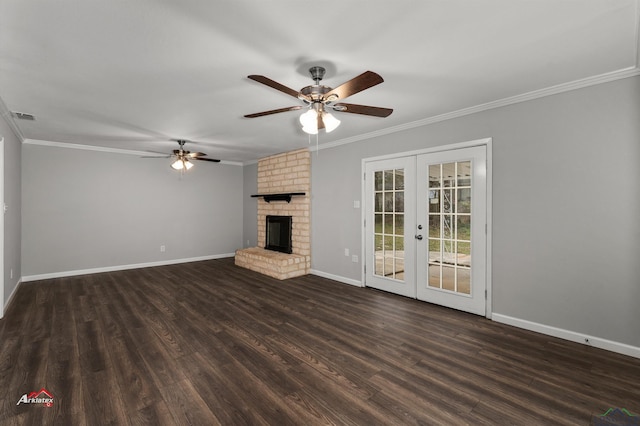 unfurnished living room with ornamental molding, a brick fireplace, dark hardwood / wood-style flooring, and french doors