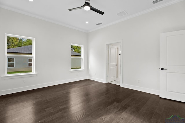 spare room featuring ceiling fan, plenty of natural light, ornamental molding, and dark wood-type flooring