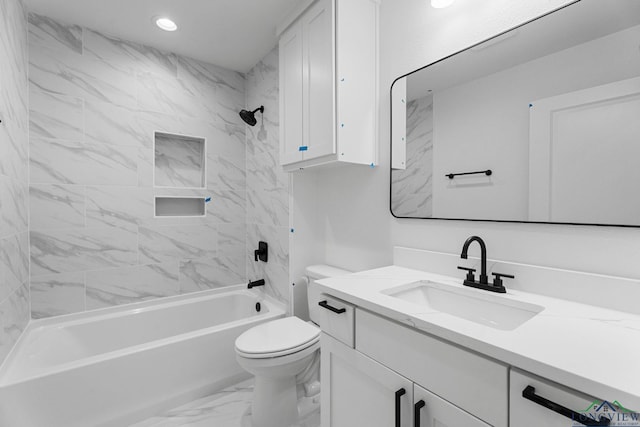 full bathroom featuring toilet, tiled shower / bath, and vanity