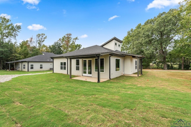 back of house featuring french doors, a patio area, and a yard