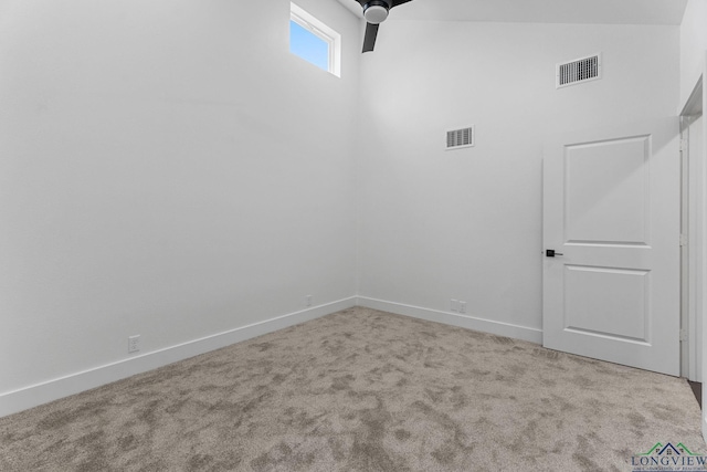 spare room with light carpet, ceiling fan, and lofted ceiling