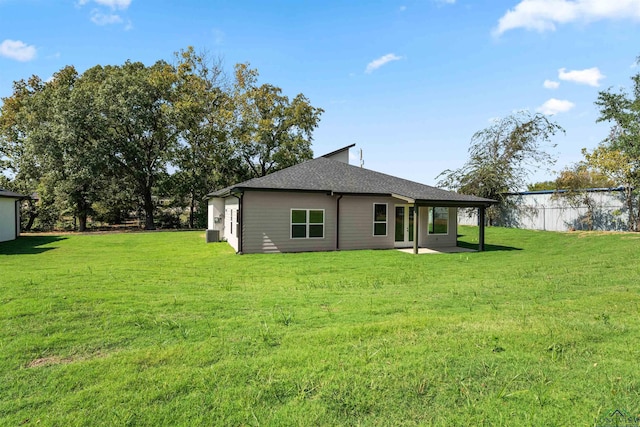 back of property with a lawn and a patio