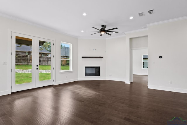 unfurnished living room with dark wood-type flooring, ceiling fan, ornamental molding, and french doors