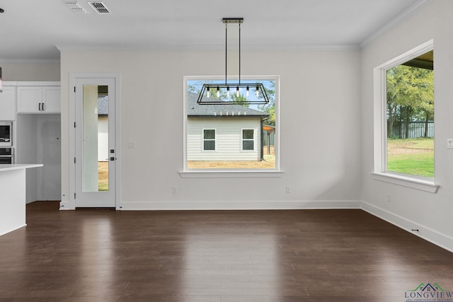 unfurnished dining area featuring dark wood-type flooring and ornamental molding