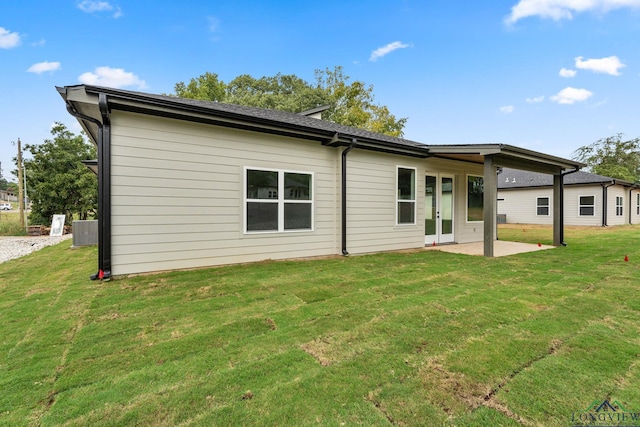 back of property featuring a yard and a patio