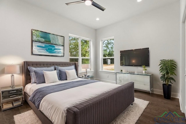 bedroom with ceiling fan and dark hardwood / wood-style flooring