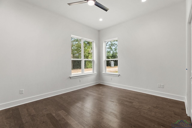 unfurnished room with ceiling fan and dark wood-type flooring