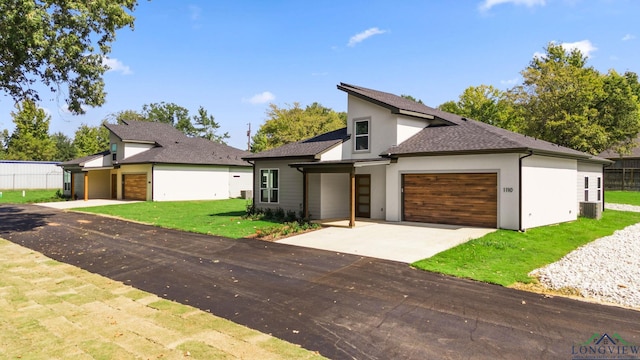 view of front of home featuring a garage and a front lawn