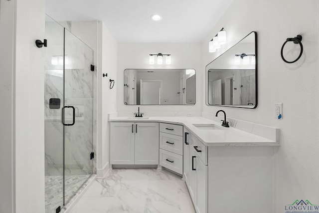 bathroom featuring an enclosed shower and vanity