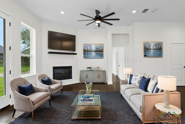 living room featuring ceiling fan, dark hardwood / wood-style floors, and ornamental molding