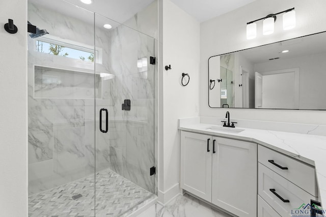 bathroom with an enclosed shower and vanity