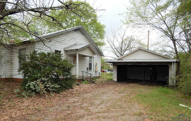 view of property exterior with an outbuilding and a garage