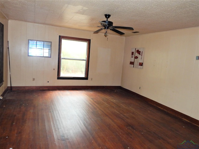 spare room featuring ceiling fan and dark hardwood / wood-style flooring