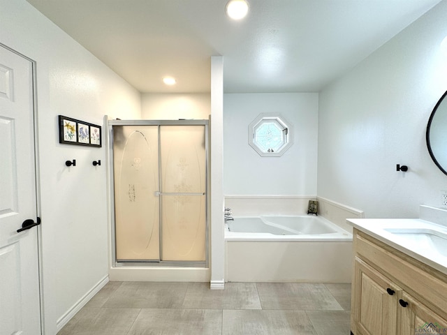 2012 W Lake Dr, Gladewater, TX 75647 - bathroom with vanity, a garden tub, a stall shower, and recessed lighting