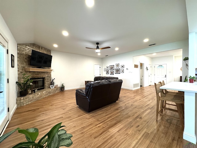2012 W Lake Dr, Gladewater, TX 75647 - living area featuring light wood-style flooring, a fireplace, ceiling fan, recessed lighting, and lofted ceiling