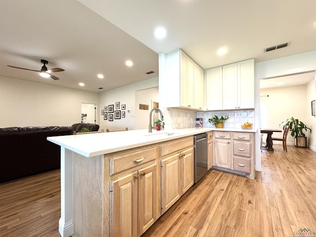 2012 W Lake Dr, Gladewater, TX 75647 - kitchen featuring dishwasher, light wood-style flooring, light countertops, open floor plan, and recessed lighting