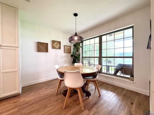 2012 W Lake Dr, Gladewater, TX 75647 - dining area featuring baseboards and light wood finished floors