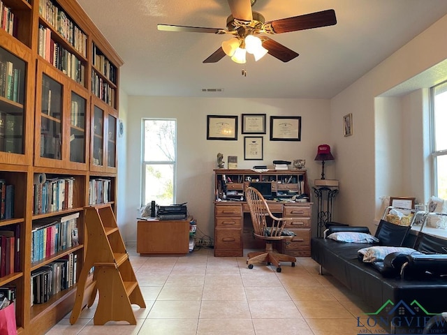 office featuring light tile patterned floors and ceiling fan