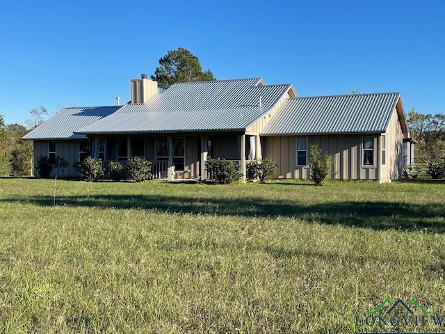 back of house with a yard