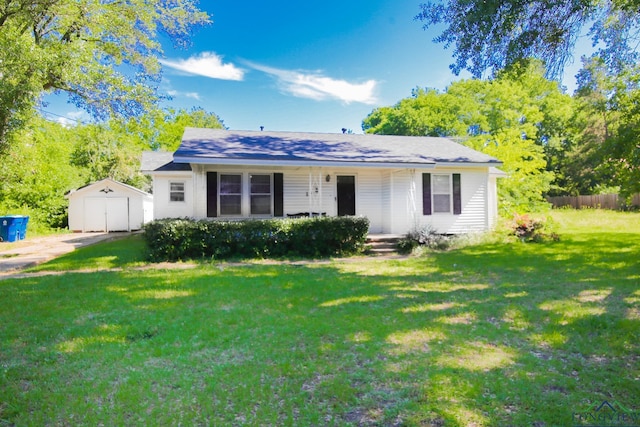 113 Fairview St, Marshall, TX 75672 - view of front of property featuring covered porch, a front yard, an outbuilding, a detached garage, and driveway