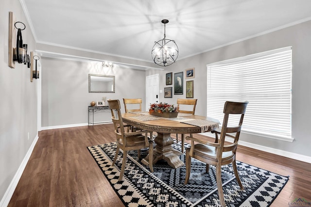 dining area with wood finished floors, ornamental molding, baseboards, and a notable chandelier