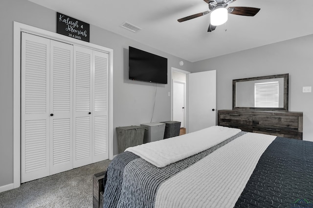 carpeted bedroom with ceiling fan, visible vents, and a closet