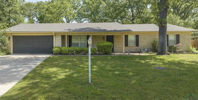 ranch-style house with an attached garage, a front lawn, brick siding, and concrete driveway