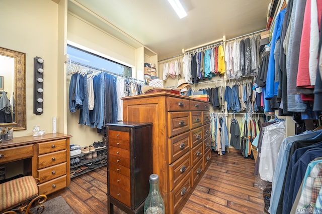 walk in closet with dark wood-style flooring