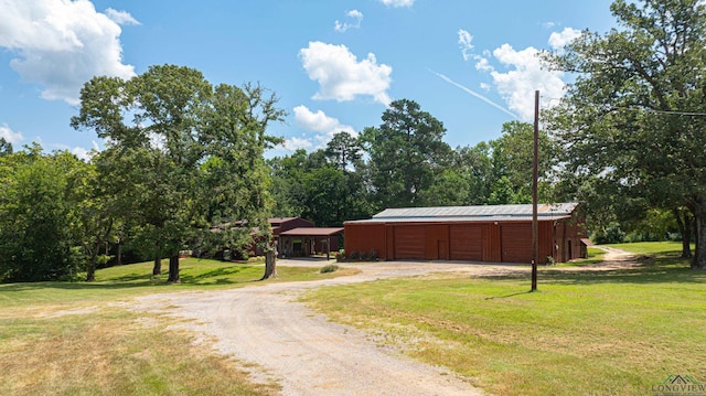 view of road featuring an outbuilding and driveway