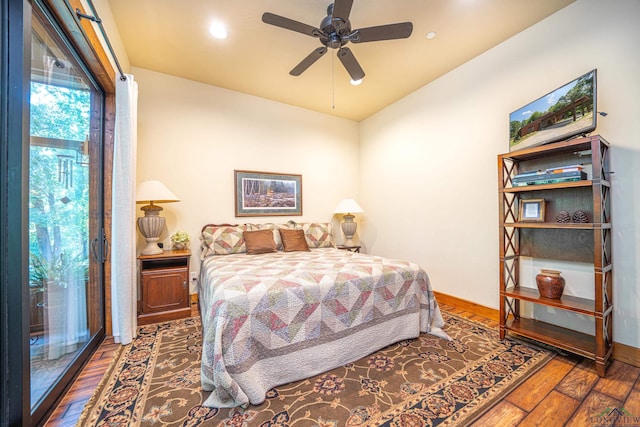 bedroom with wood finished floors, a ceiling fan, and baseboards