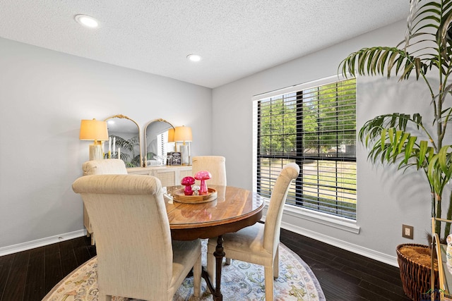 dining space with a textured ceiling, baseboards, recessed lighting, and dark wood finished floors
