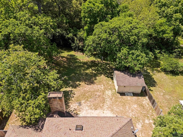 bird's eye view with a wooded view