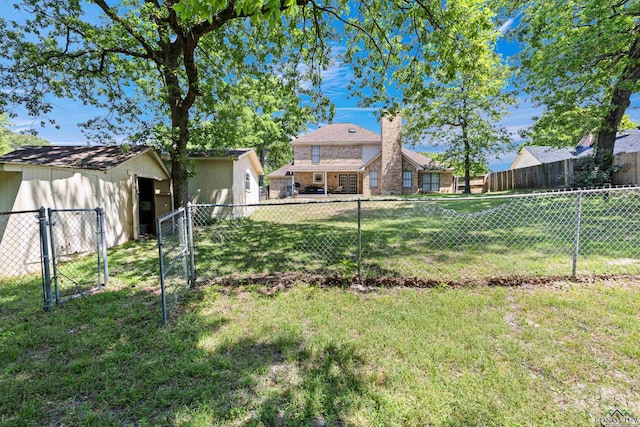 view of yard featuring a fenced backyard and a gate
