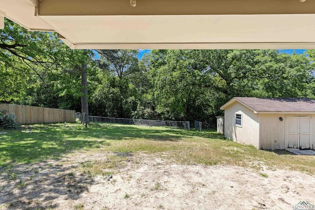 view of yard with an outbuilding and fence
