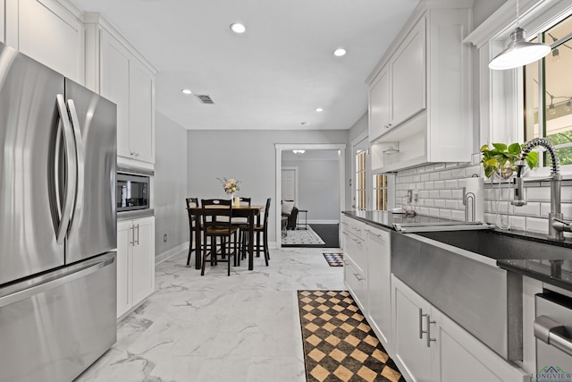 kitchen featuring stainless steel appliances, tasteful backsplash, visible vents, recessed lighting, and white cabinets