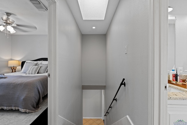 interior space with visible vents, baseboards, and a skylight