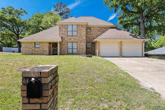 traditional-style house with a garage, a front lawn, brick siding, and driveway