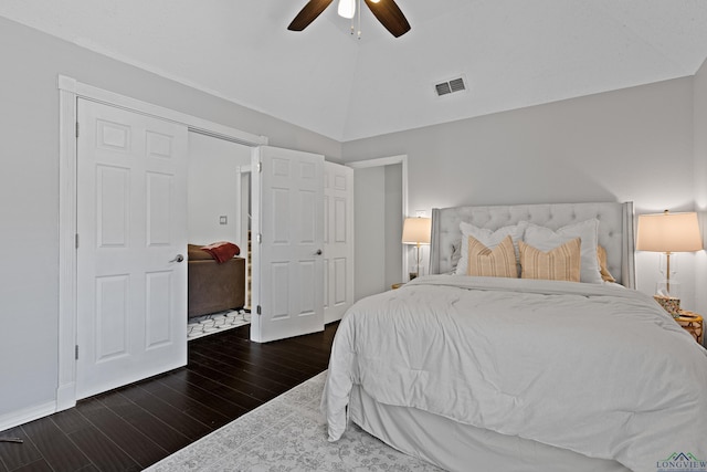 bedroom featuring ceiling fan, lofted ceiling, visible vents, and wood finished floors