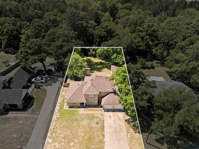 birds eye view of property with a view of trees