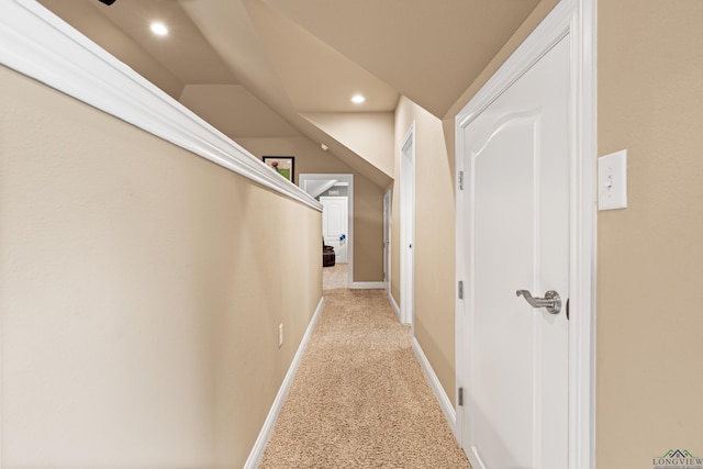 corridor with lofted ceiling, light colored carpet, recessed lighting, and baseboards