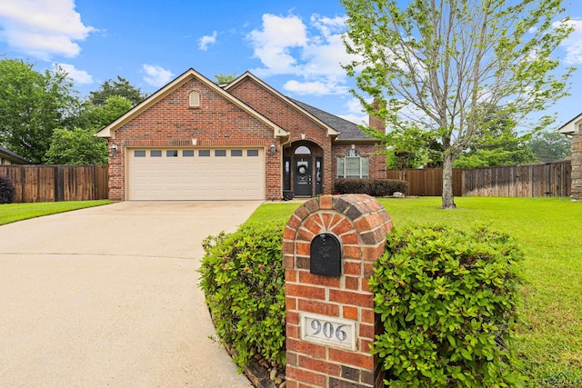 ranch-style home with brick siding, fence, a front lawn, and an attached garage