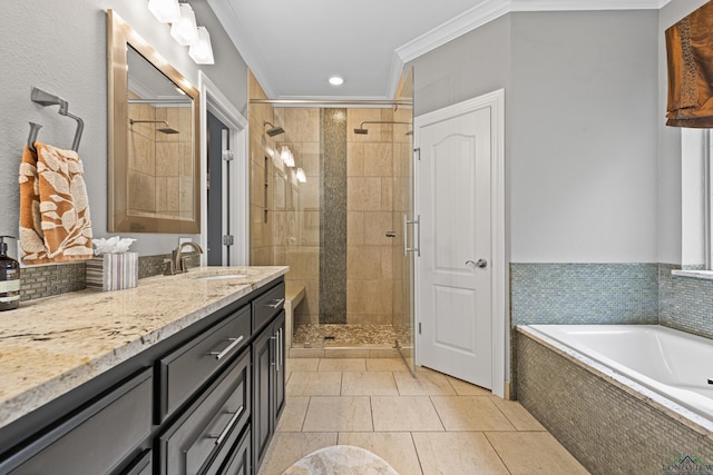 full bathroom featuring vanity, a garden tub, tile patterned floors, a stall shower, and ornamental molding