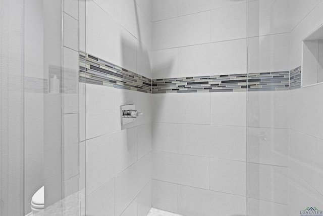 bathroom with tiled shower