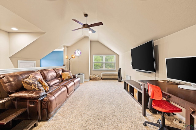carpeted living area featuring a ceiling fan and vaulted ceiling