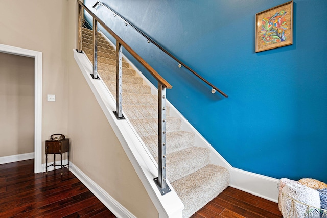 stairs featuring hardwood / wood-style floors and baseboards
