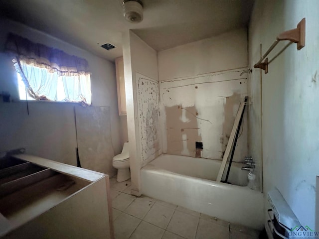 bathroom with tile patterned floors, toilet, and  shower combination