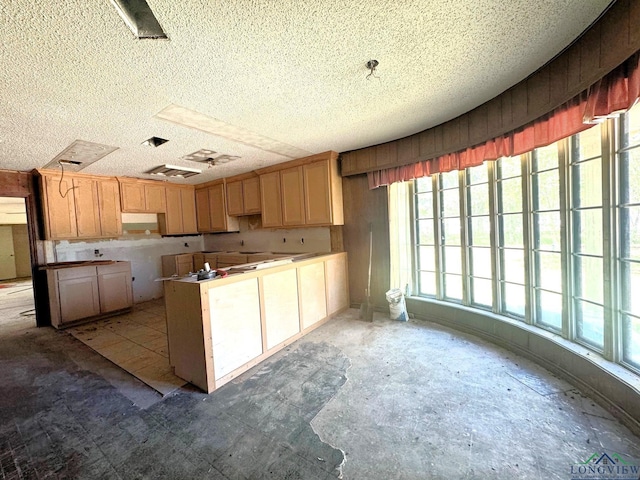 kitchen featuring a textured ceiling and light brown cabinets