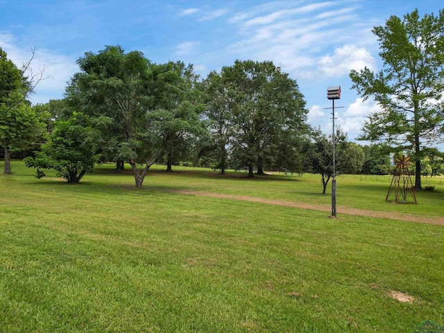 591 N Live Oak Rd, Gilmer, TX 75644 - view of grassy yard with view of wooded area