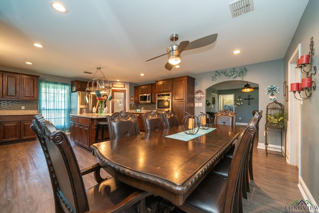 dining room with dark hardwood / wood-style floors and ceiling fan